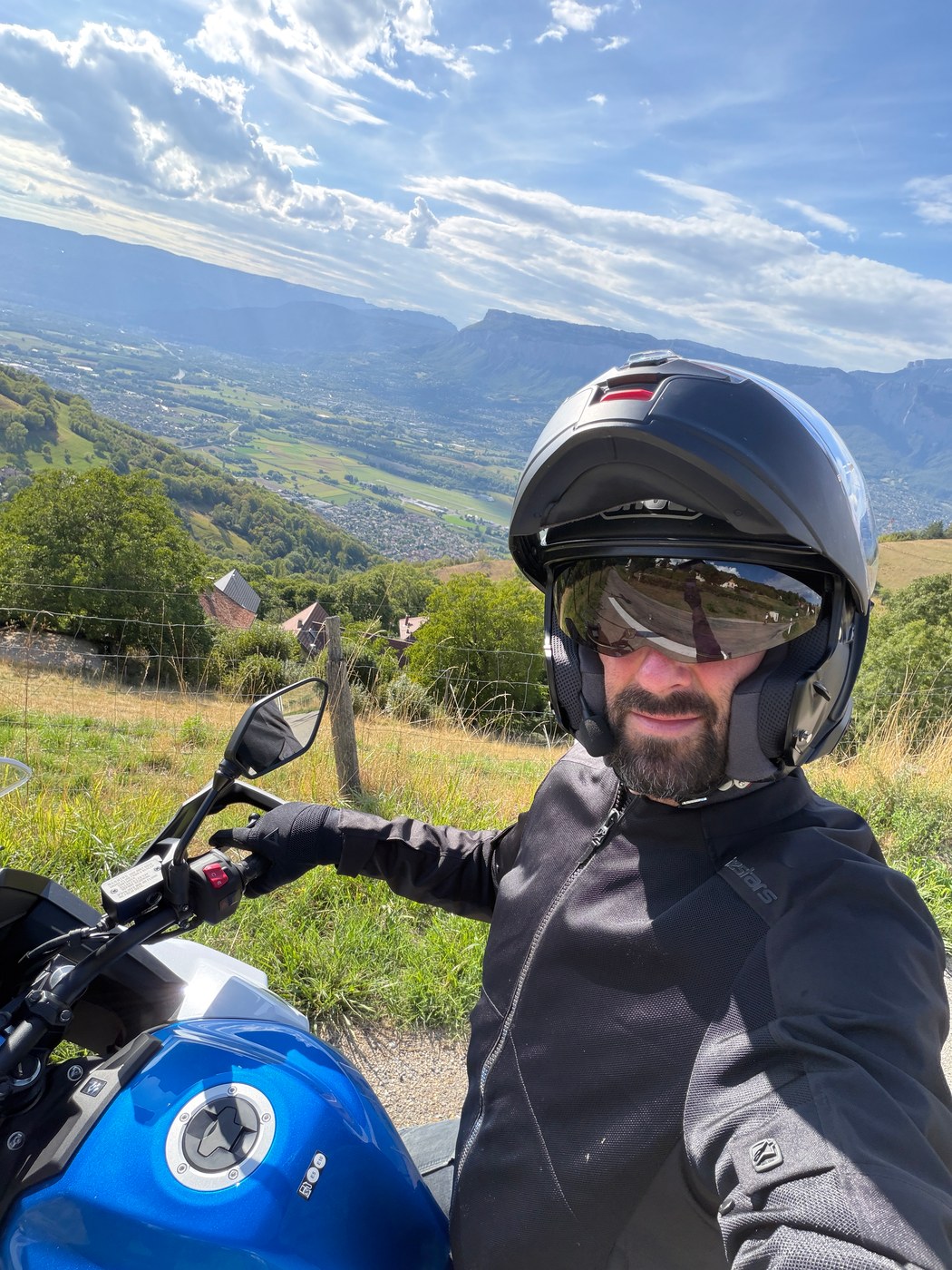 Xavier riding on the Belledonne balcony road: at 1.90 m, perfectly at home, and thoroughly enjoying it.